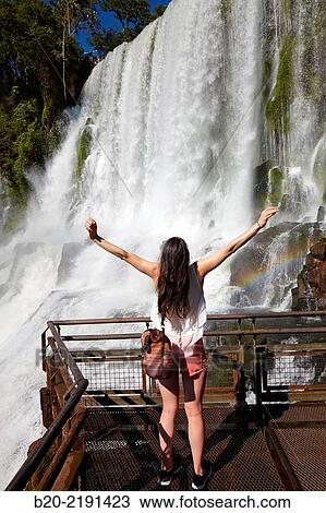 Young woman. Iguaz Falls. Iguaz National Park. Argentina/Brazil View Large Photo Image Stock Image - Young woman. Iguaz Falls. Iguaz National Park. Argentina/Brazil. Fotosearch