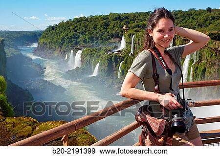 Stock Photo - Young woman. Iguaz Falls. Iguaz National Park. Argentina/Brazil. Fotosearch