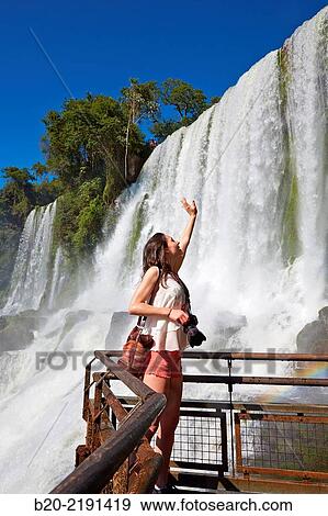 Stock Photo - Young woman. Iguaz Falls. Iguaz National Park. Argentina/Brazil. Fotosearch