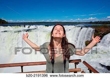 Young woman. Iguaz Falls. Iguaz National Park. Argentina/Brazil View Large Photo Image Stock Photograph - Young woman. Iguaz Falls. Iguaz National Park. Argentina/Brazil. Fotosearch