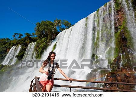Young woman. Iguaz Falls. Iguaz National Park. Argentina/Brazil View Large Photo Image Stock Photograph - Young woman. Iguaz Falls. Iguaz National Park. Argentina/Brazil. Fotosearch