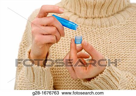 Young woman in a beige turtleneck pullover, counting homeopathic pills out of a blue tube View Large Photo Image Stock Image - Young woman in a beige turtleneck pullover, counting homeopathic pills out of a blue tube. Fotosearch