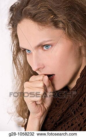young woman in a brown shawl coughing with her hand in front of her mouth View Large Photo Image Stock Image - young woman in a brown shawl coughing with her hand in front of her mouth. Fotosearch