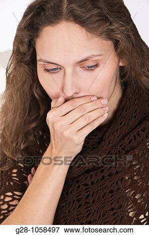 young woman in a brown shawl, coughing with her hand in front of her mouth View Large Photo Image Stock Photo - young woman in a brown shawl, coughing with her hand in front of her mouth. Fotosearch