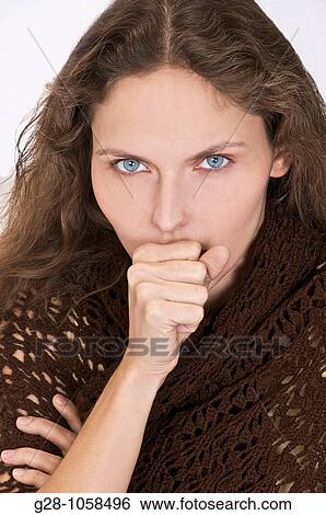 young woman in a brown shawl, coughing with her hand in front of her mouth View Large Photo Image Stock Photograph - young woman in a brown shawl, coughing with her hand in front of her mouth. Fotosearch