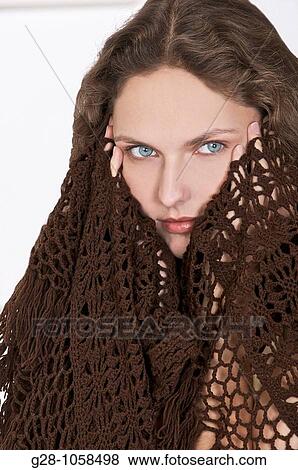 young woman in a brown shawl, holding her temples because of a headache View Large Photo Image Stock Photo - young woman in a brown shawl, holding her temples because of a headache. Fotosearch