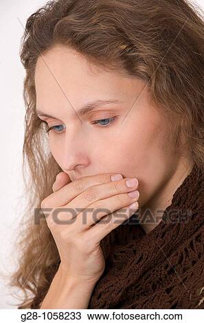 young woman in a brown shawl talking in a low voice and hiding her mouth with her hand to tell secrets View Large Photo Image Stock Image - young woman in a brown shawl talking in a low voice and hiding her mouth with her hand to tell secrets. Fotosearch