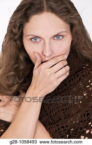 young woman in a brown shawl, with her hand in front of her mouth, thinking, hesitating, trying to remember something View Large Photo Image Stock Image - young woman in a brown shawl, with her hand in front of her mouth, thinking, hesitating, trying to remember something. Fotosearch