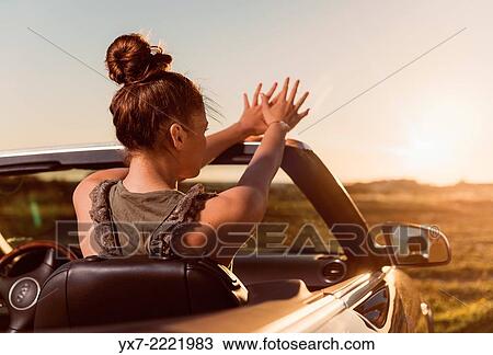 Stock Image - Young woman in a convertible car. Tarifa, Cadiz, Andalusia, Spain, Europe.. Fotosearch