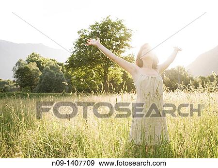 Stock Photo - Young woman in a field. Fotosearch