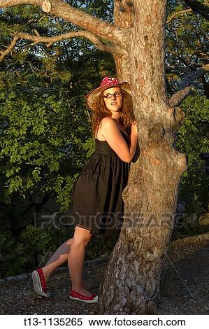 Stock Photography - Young woman in a park, sunset light. Fotosearch