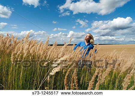 Young woman in a wheat field in a russian village, Kirillovka, Russian Federation View Large Photo Image Stock Photo - Young woman in a wheat field in a russian village, Kirillovka, Russian Federation. Fotosearch