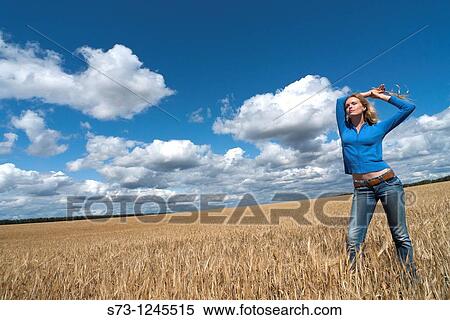 Young woman in a wheat field in a russian village, Kirillovka, Russian Federation View Large Photo Image Stock Photography - Young woman in a wheat field in a russian village, Kirillovka, Russian Federation. Fotosearch
