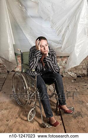 Stock Image - Young woman in a wheelchair. Fotosearch