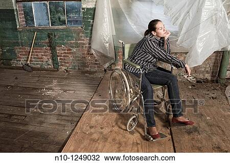 Young woman in a wheelchair View Large Photo Image Stock Image - Young woman in a wheelchair. Fotosearch