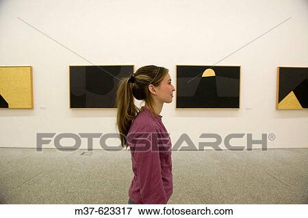 Stock Photo - Young woman in art gallery. Fotosearch