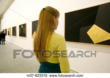 Young woman in art gallery View Large Photo Image Stock Photo - Young woman in art gallery. Fotosearch