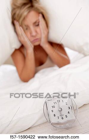 Young woman in bed with pillow on her head View Large Photo Image Stock Image - Young woman in bed with pillow on her head. Fotosearch