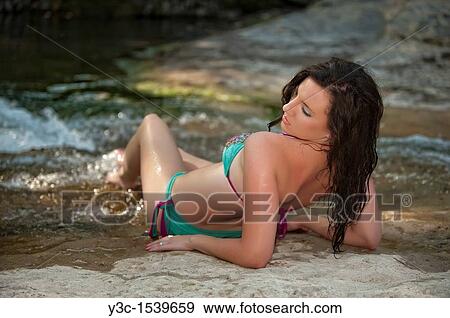 Young woman in bikini enjoying river water View Large Photo Image Stock Photo - Young woman in bikini enjoying river water. Fotosearch