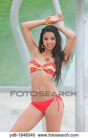 Stock Photography - Young woman in bikini looking at camera, Miami Beach, Florida, USA. Fotosearch