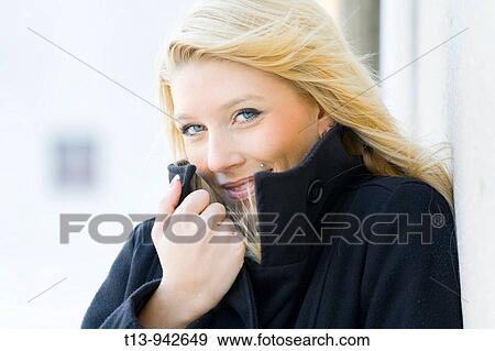 Young woman in Black coat, cold wind blowing View Large Photo Image Stock Photo - Young woman in Black coat, cold wind blowing. Fotosearch