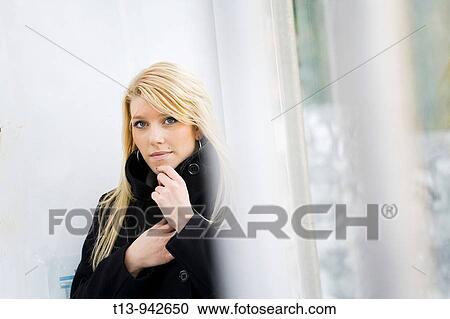 Young woman in Black coat, it's cold View Large Photo Image Stock Image - Young woman in Black coat, it's cold. Fotosearch