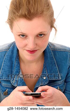 Young woman in blue holding a phone and sending a mail View Large Photo Image Stock Image - Young woman in blue holding a phone and sending a mail. Fotosearch