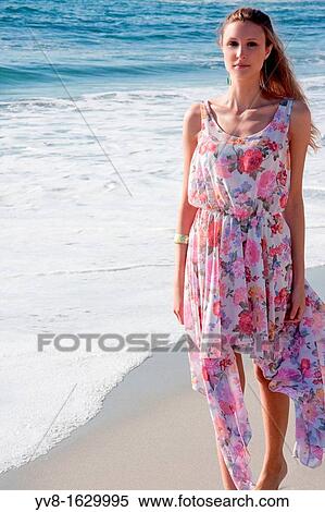 Stock Photography - Young woman in colorful dress. Fotosearch