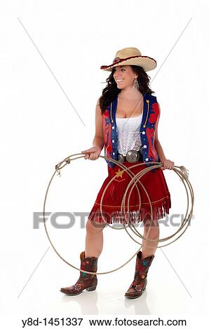Young woman in cowgirl outfit holding rope View Large Photo Image Stock Photo - Young woman in cowgirl outfit holding rope. Fotosearch