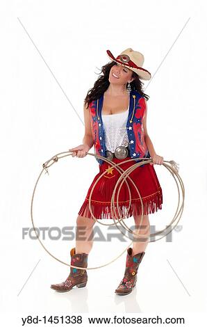 Stock Photo - Young woman in cowgirl outfit holding rope. Fotosearch
