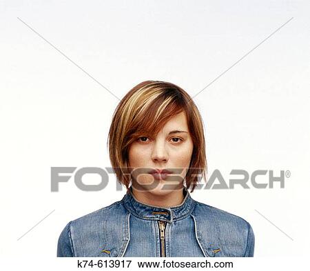 young woman in denim jacket gazing at viewer View Large Photo Image Stock Photo - young woman in denim jacket gazing at viewer. Fotosearch