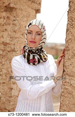 Stock Image - Young woman in El Bad? Palace, wearing a headscarf, Marrakech, Morocco. Fotosearch