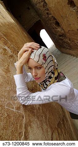 Stock Photography - Young woman in El Bad? Palace, wearing a headscarf, Marrakech, Morocco. Fotosearch