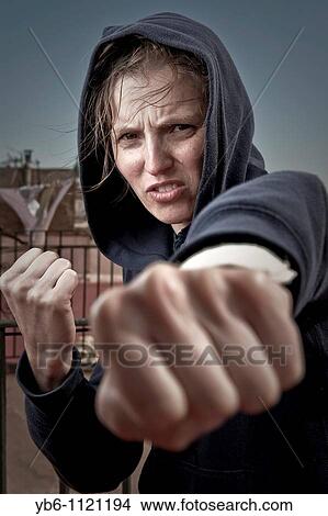 Picture - Young woman in fighting pose. Fotosearch