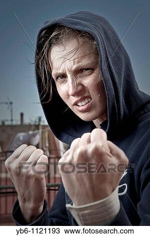 Young woman in fighting pose View Large Photo Image Stock Image - Young woman in fighting pose. Fotosearch