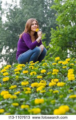 Young woman in flowers View Large Photo Image Stock Image - Young woman in flowers. Fotosearch