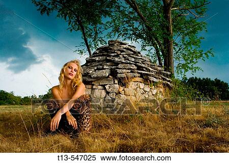 Young woman in front of Istrian? kazun? stone hut just before the storm, Croatia, Europe View Large Photo Image Stock Photography - Young woman in front of Istrian? kazun? stone hut just before the storm, Croatia, Europe. Fotosearch