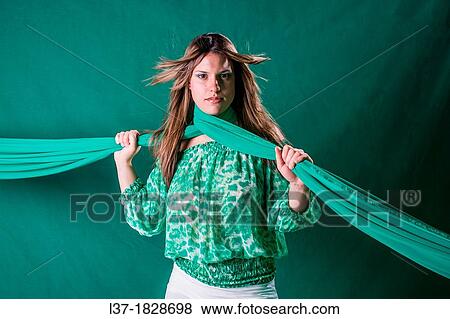 Young woman in green holding a scarf around her neck View Large Photo Image Stock Photo - Young woman in green holding a scarf around her neck. Fotosearch