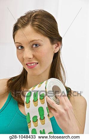 young woman in green presenting with humour a roll of toilet paper printed with green cactuses to suggest hemoroidal or ather toilet problems View Large Photo Image Stock Image - young woman in green presenting with humour a roll of toilet paper printed with green cactuses to suggest hemoroidal or ather toilet problems. Fotosearch