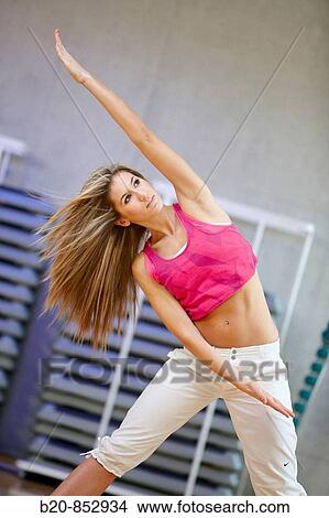 Young woman in gym, dance exercise, aerobics, fitness View Large Photo Image Picture - Young woman in gym, dance exercise, aerobics, fitness. Fotosearch