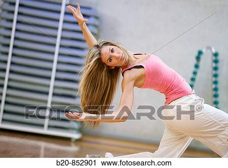 Stock Image - Young woman in gym, dance exercise, aerobics, fitness. Fotosearch