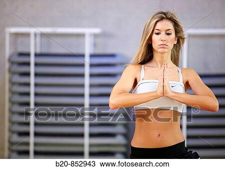 Young woman in gym doing yoga View Large Photo Image Stock Image - Young woman in gym doing yoga. Fotosearch