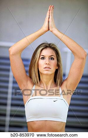 Young woman in gym doing yoga View Large Photo Image Stock Image - Young woman in gym doing yoga. Fotosearch