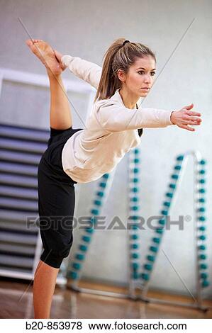 Young woman in gym doing yoga View Large Photo Image Stock Photo - Young woman in gym doing yoga. Fotosearch