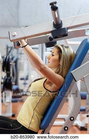 Young woman in gym View Large Photo Image Stock Image - Young woman in gym. Fotosearch