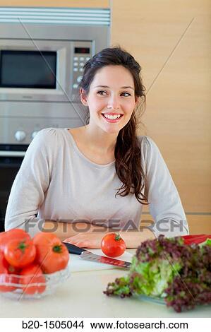 Young woman in kitchen View Large Photo Image Picture - Young woman in kitchen. Fotosearch