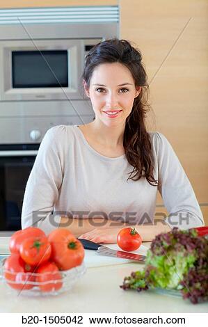Young woman in kitchen View Large Photo Image Stock Image - Young woman in kitchen. Fotosearch