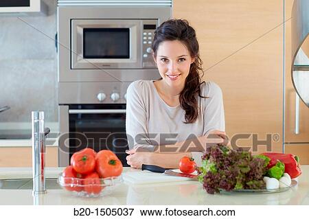 Young woman in kitchen View Large Photo Image Stock Photo - Young woman in kitchen. Fotosearch