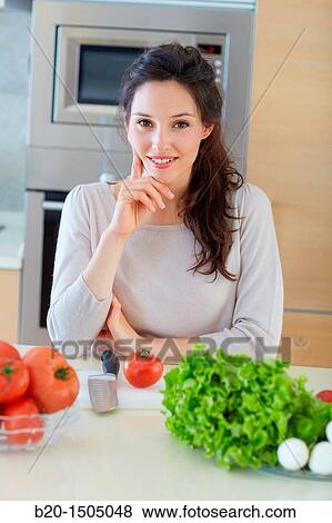 Young woman in kitchen View Large Photo Image Stock Photo - Young woman in kitchen. Fotosearch