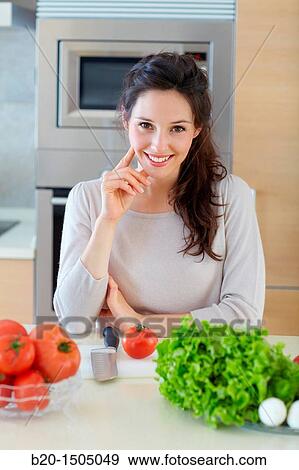 Young woman in kitchen View Large Photo Image Stock Photo - Young woman in kitchen. Fotosearch